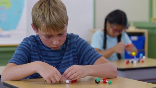 Elementary students building science models in a bright school classroom