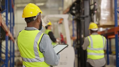 Warehouse worker controlling boxes in warehouse