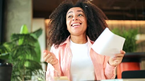 Excited Woman Receives Good News at Desk