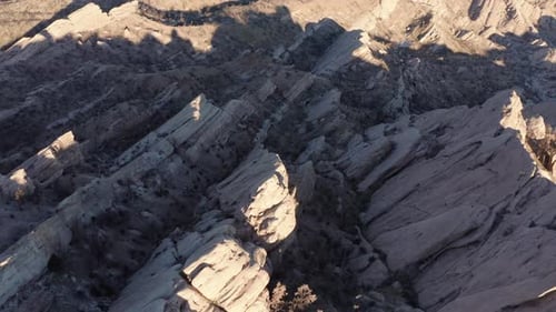 A drone flies over the Devil's Punchbowl, revealing a breathtaking view of the rugged, layered rock