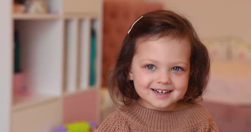 Adorable Young Girl Playing with Blocks