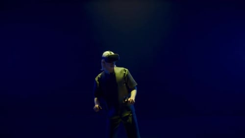 Man Using VR Headset and Controllers in Studio