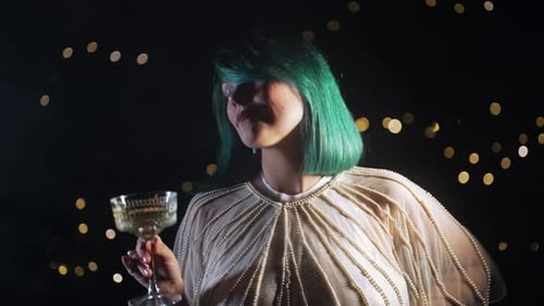 Woman with Green Hair Holding Champagne at a Party