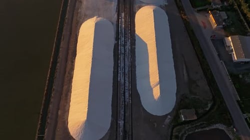 Aerial view of salt pans and factory at sunset, Greece.