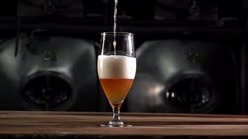 Craft Beer Poured at 1000 Fps Showing Slow Motion Action in a Glass With Bubbles and Foam From the