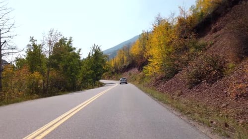 POV footage of driving in the Rocky Mountains of Colorado in fall season