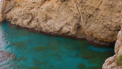 Shot of turquoise water at Cove cave Sicily during daytime.