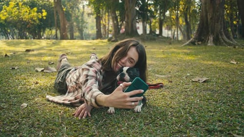 Woman Taking Selfie with Dog in Park