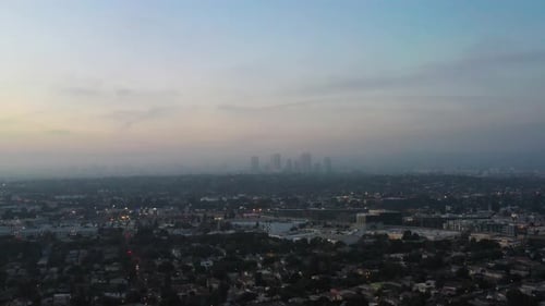 Aerial View Of City Of Los Angeles At Sunrise In California, USA. Foggy Skyline In Distance.