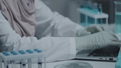 Scientist Typing in a High Tech Modern Lab