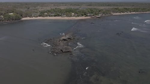 Smooth Flight Along the Coast Above Reef Rock Formations