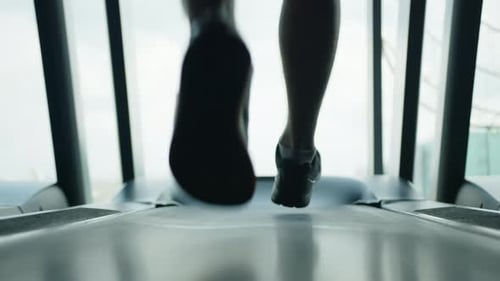 Male Fit Legs From Knees to Toes in Black Sneakers Running on Treadmill in Gym