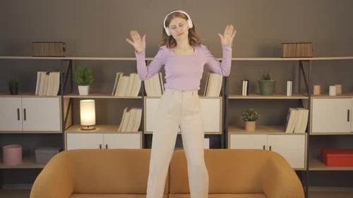 Woman Dancing Energetically to Music at Home