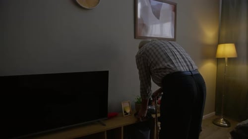 Senior Man Taking Blood Pressure in Bedroom