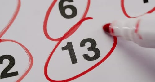 Circling Date on Calendar Page with Red Marker