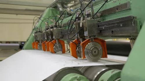 Industrial Machine Cutting Continuous Sheet of Material