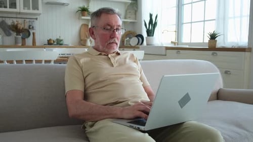 Man Using Laptop in Bright, Modern Home