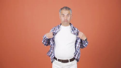 Man Wearing Plaid Shirt is Hot and Fans Himself