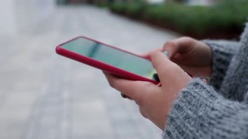 Close Up of Young Woman Hands Using Smartphone Phone in City Street