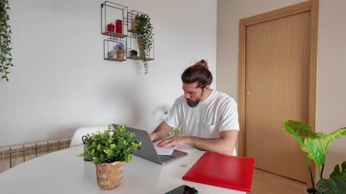 Man Working at Laptop Inside Modern Home