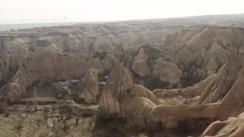 Aerial video of a panoramic view of natural rock formations in Cappadocia, Turkey