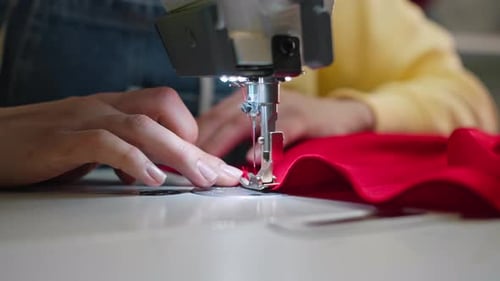 Close-Up Sewing Machine Stitching Red Fabric