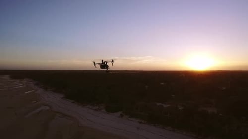 Aerial Drone Quad Copter Footage Flying Over Tropical Area And Towards The Sun.