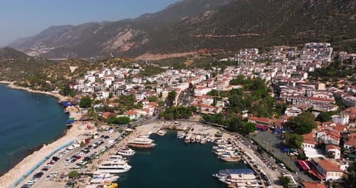 Long drone dolly above Kas, Antalya, Turkey, showing the town’s rooftops, marina, and coastal scener