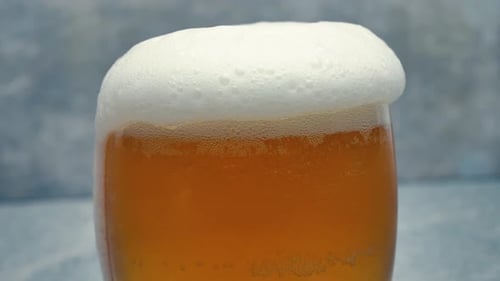 Foamy Beer Being Poured into Glass Close Up