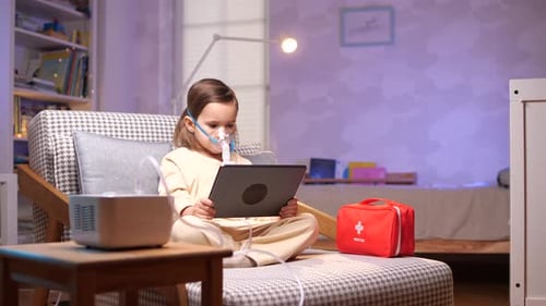 Child Using Tablet with Medical Mask at Home