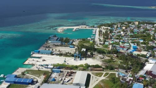 Aerial Scenic Shot Of Structures On Island, Drone Flying Forward Over Turquoise Sea