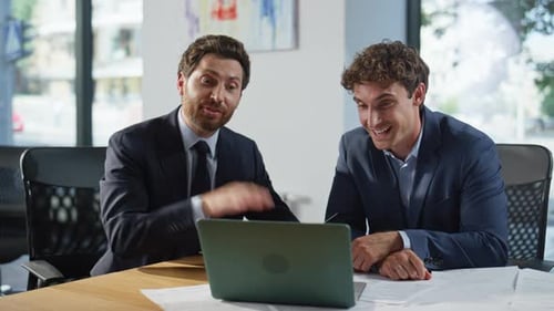 Businessmen Talking on Laptop in Bright Office