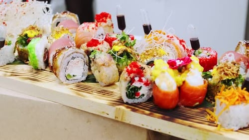 Japanese sushi. Set of beautiful sushi roll on a wooden board. Buffet before the event. Close-up