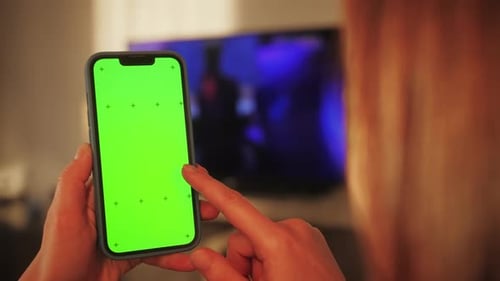 Young Woman Sitting on a Couch with Green Screen Smartphone Girl Using Mobile Phone Using Smartphone