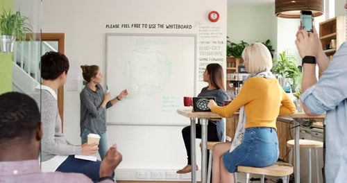 Young Professionals Collaborating on Business Strategy in Modern Office