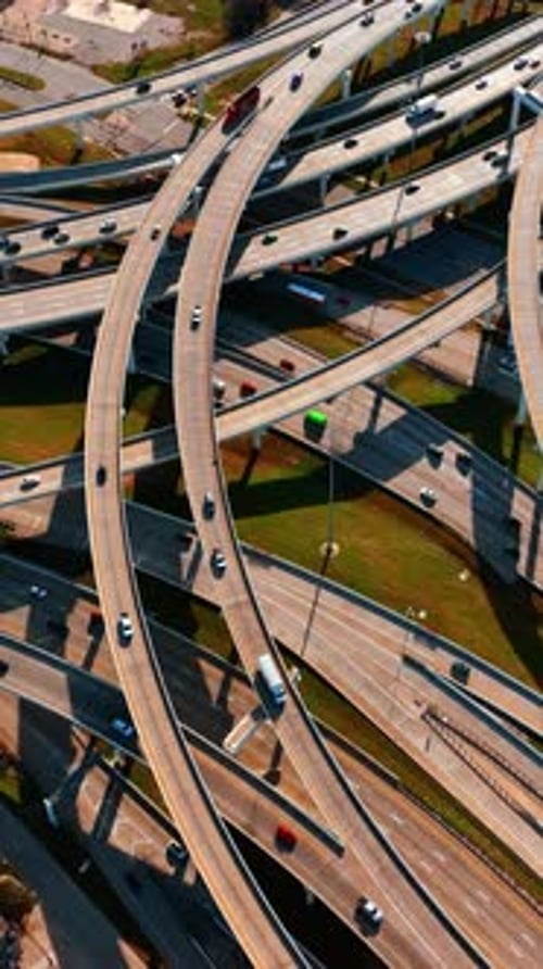 Freeways crossing in Dallas, Texas, USA. Top view on the cars going by the roads at daytime.
