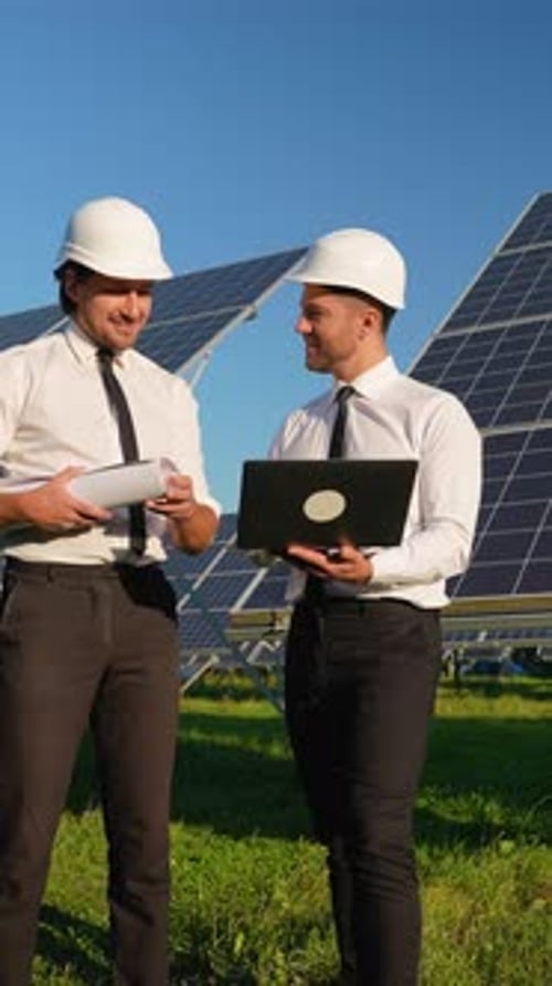 Two Engineers Analyze Solar Energy Project Onsite