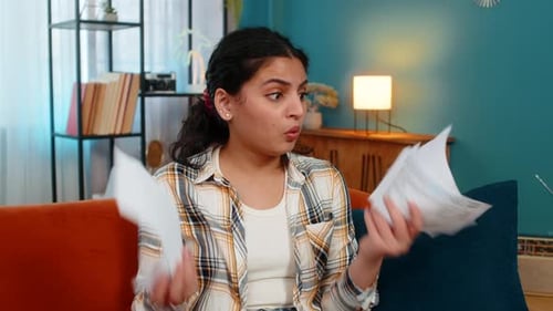 Shocked Woman Reading Bills at Home