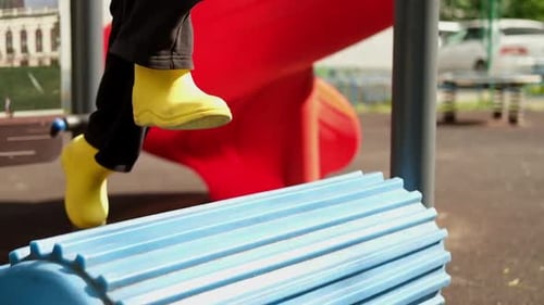 Child Boy is Running on the Simulator of Trainer Look Like Drum Treadmill at the Outdoor Playground