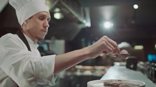 Chef Garnishing Food in Commercial Kitchen