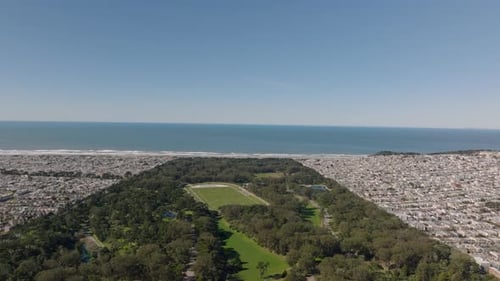 Forwards Fly Above Urban Park Surrounded By Residential Urban Districts and Ocean Coast San
