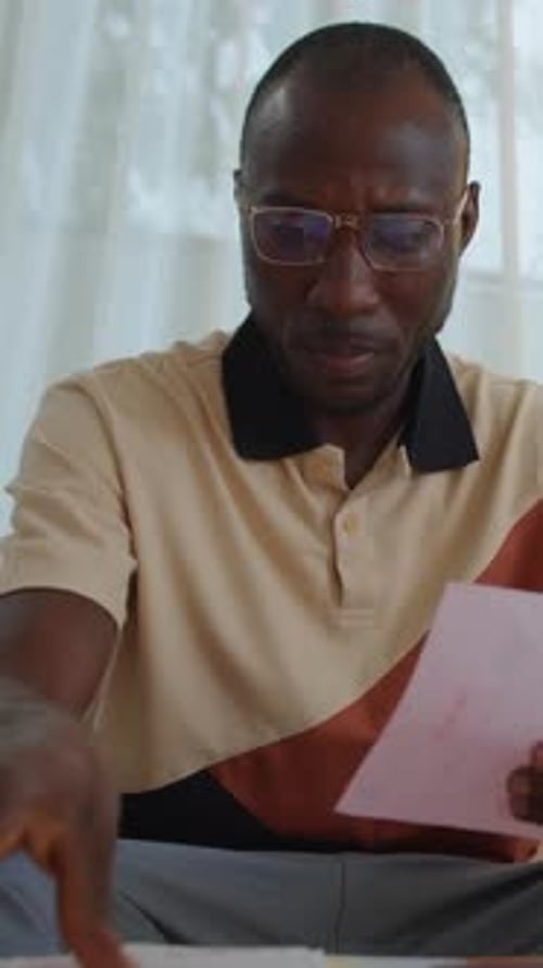 Black Man Checking Utility Bills