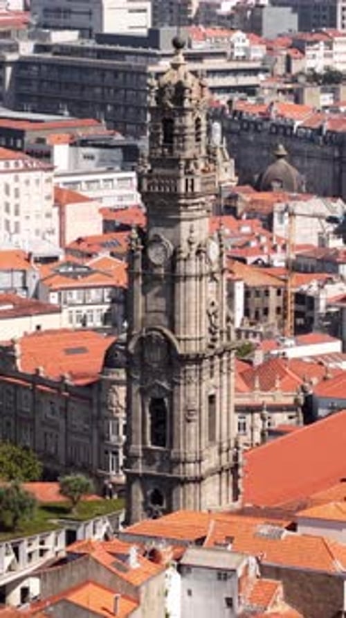 Porto, Portugal. Vertical Drone Shot of Clerigos Church Tower and Old Town Buildings