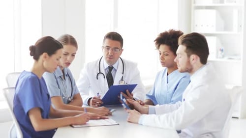 Hospital, Profession, People And Medicine Concept - Group Of Doctors With Clipboard Meeting And D...