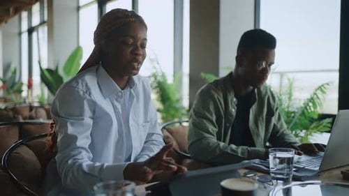 Business Meeting in the Cafe Between Two Driven Black Professionals Discussing Future Plans