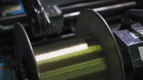 Shiny Wire Being Spooled By An Industrial Machine