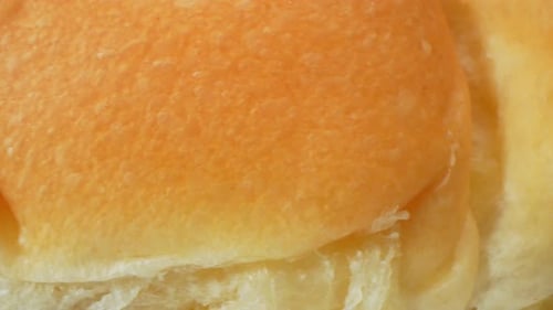 Close Up of Two Soft Golden Dinner Rolls