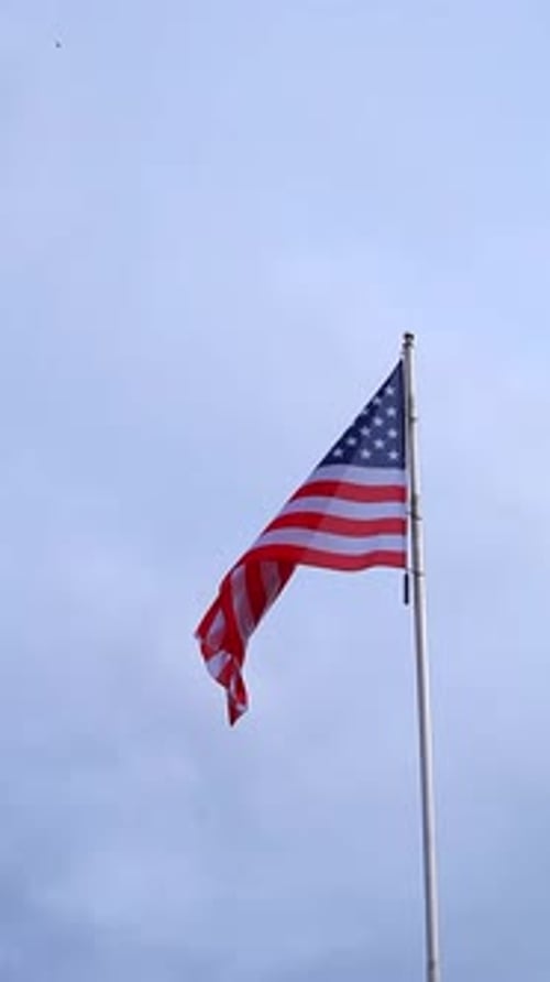 American Flag Waving Against Blue Sky