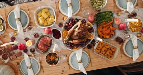 Overhead View of Thanksgiving Table Setting with Turkey