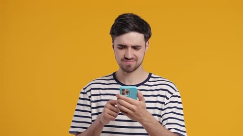 Man Using Mobile Phone with Negative Expression